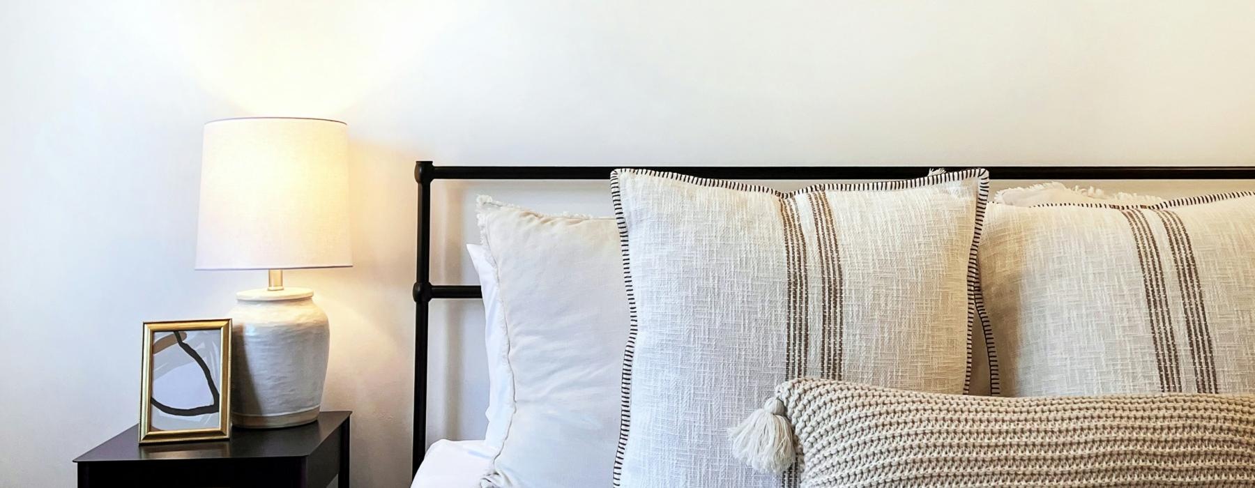 a bed with a lamp on the side