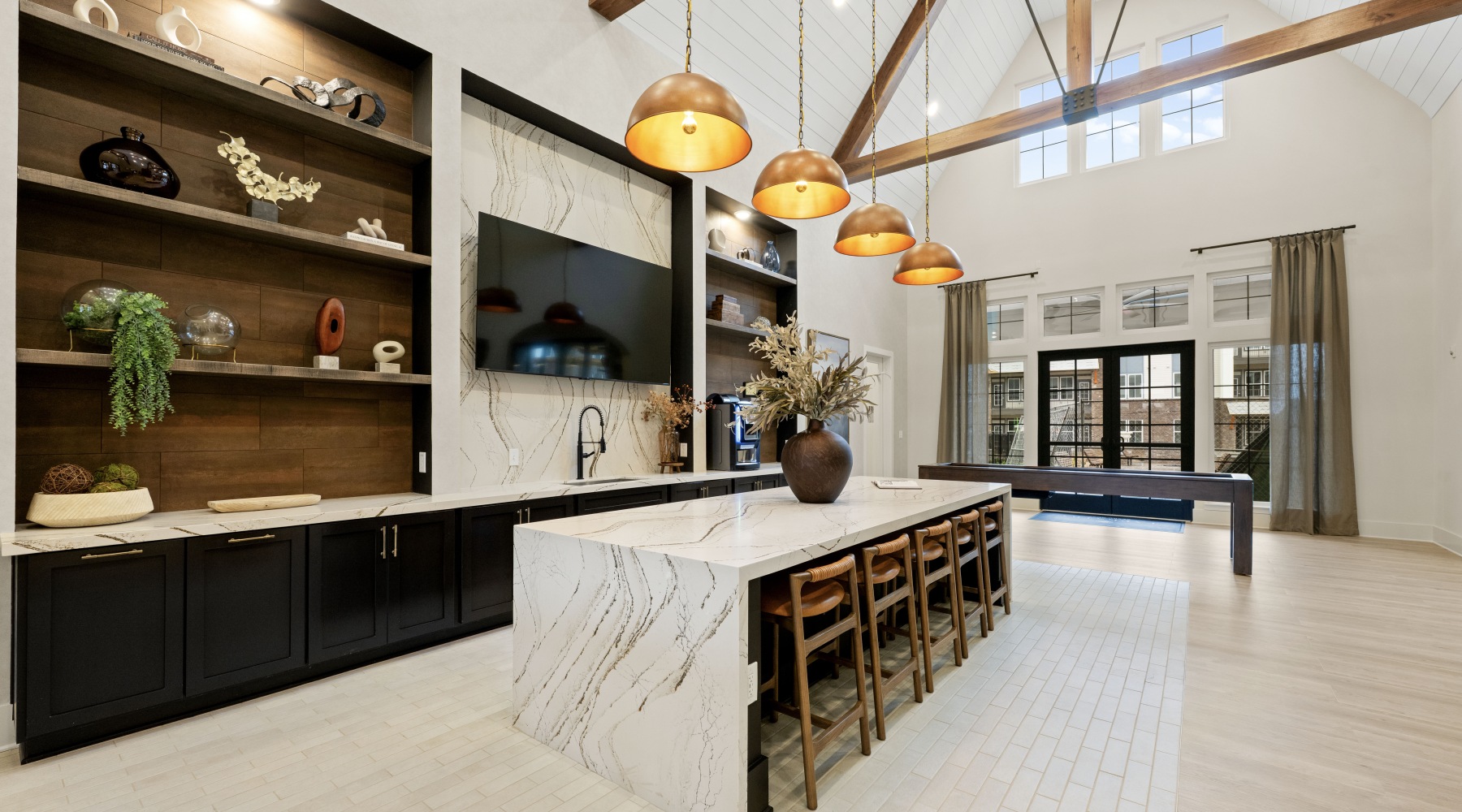 modern clubhouse kitchen with island and tv 