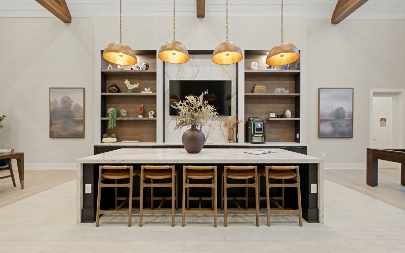 clubhouse kitchen with island seating for five and large tv behind the island