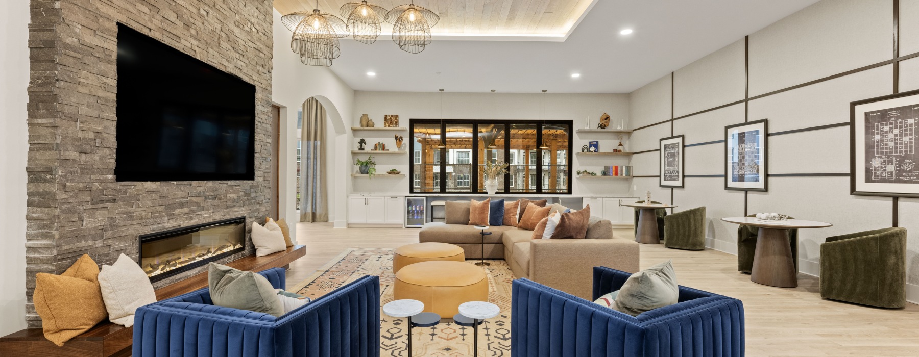 resident social lounge with a fireplace and tv 