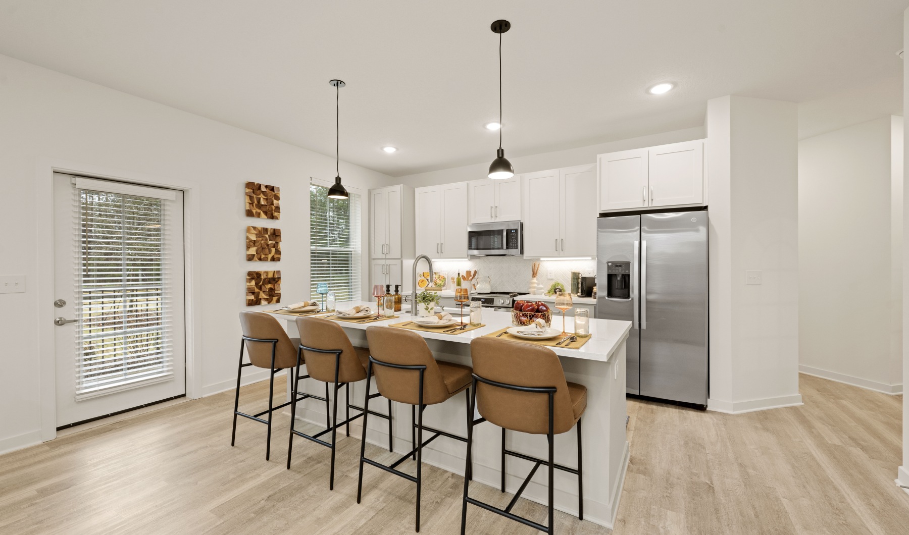 kitchen with a large island and a door to access the private patio in the Bristle floor plan