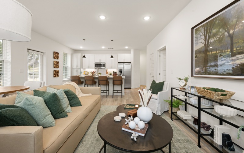 close up of the living room area with  neutral colors and green accents throughout